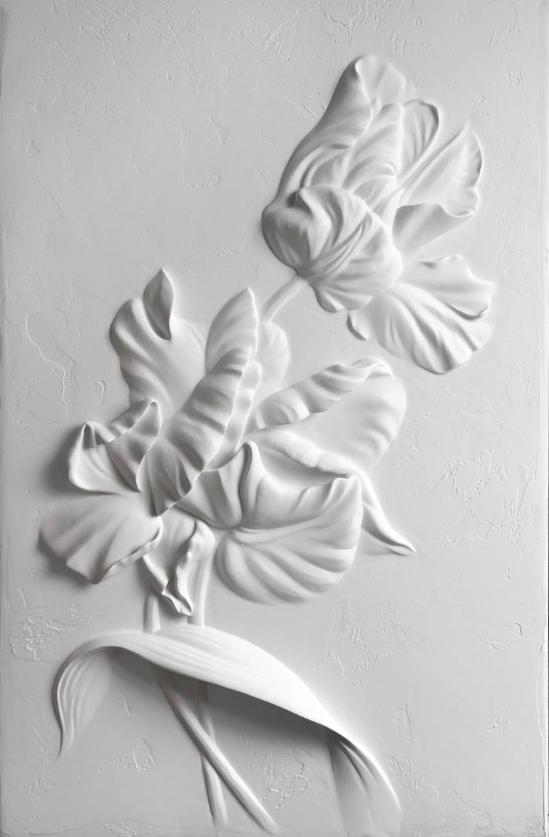 Textured 3D floral plaster relief sculpture on a white wall