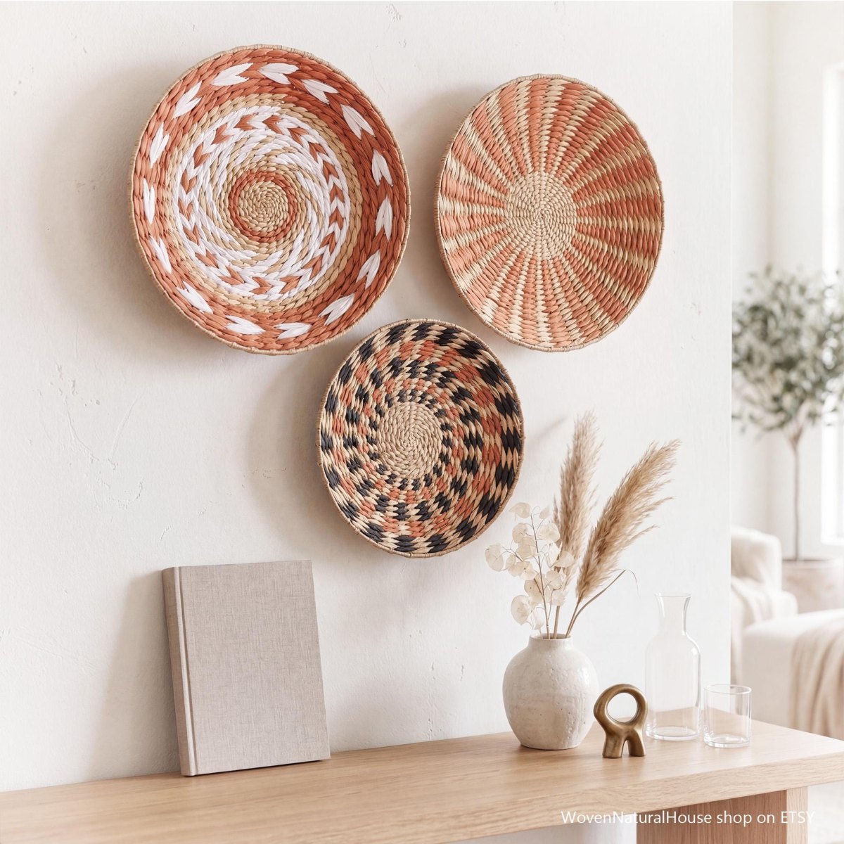 Woven wall baskets in terracotta and natural tones on a white wall