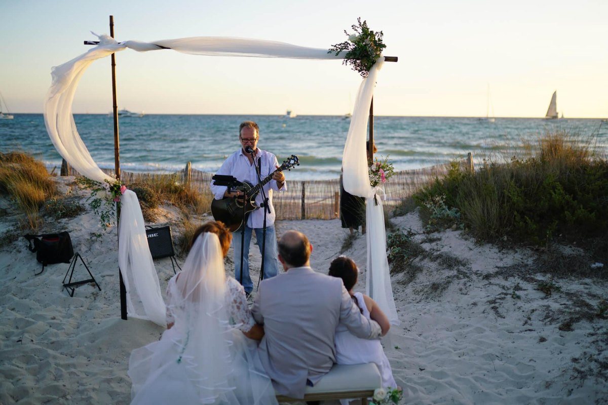 Beach wedding guests enjoying live music