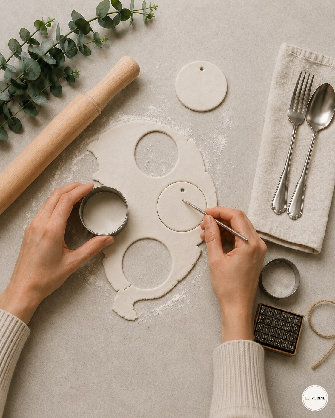 Cutting circle shapes from air dry clay and adding a hanging hole by hand
