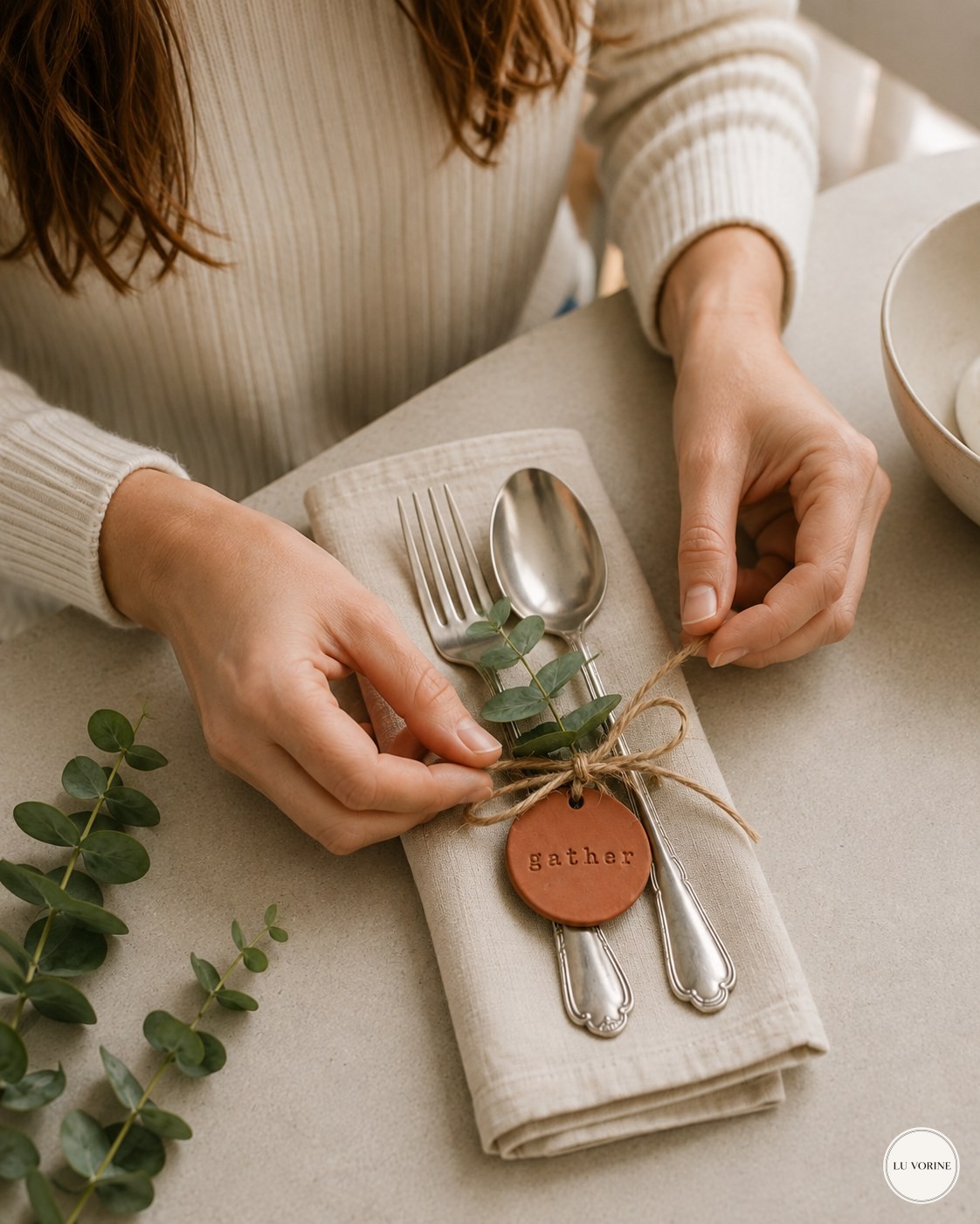Finishing the knot on an air dry clay napkin ring at a home place setting