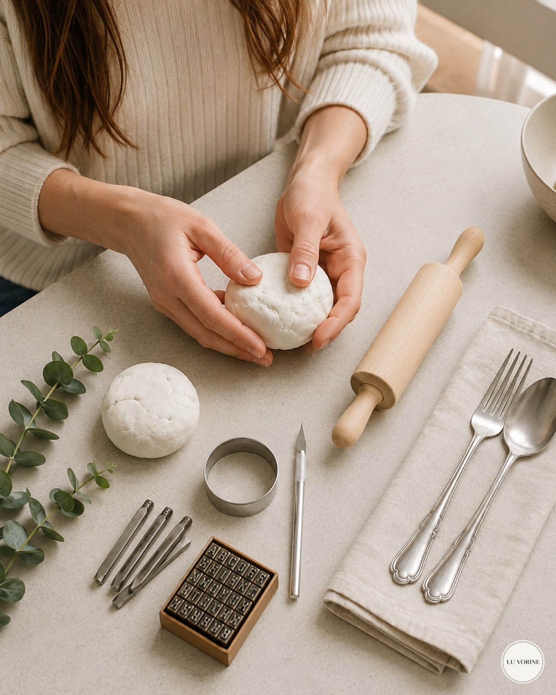 Kneading a ball of white air dry clay at a home table before making napkin rings