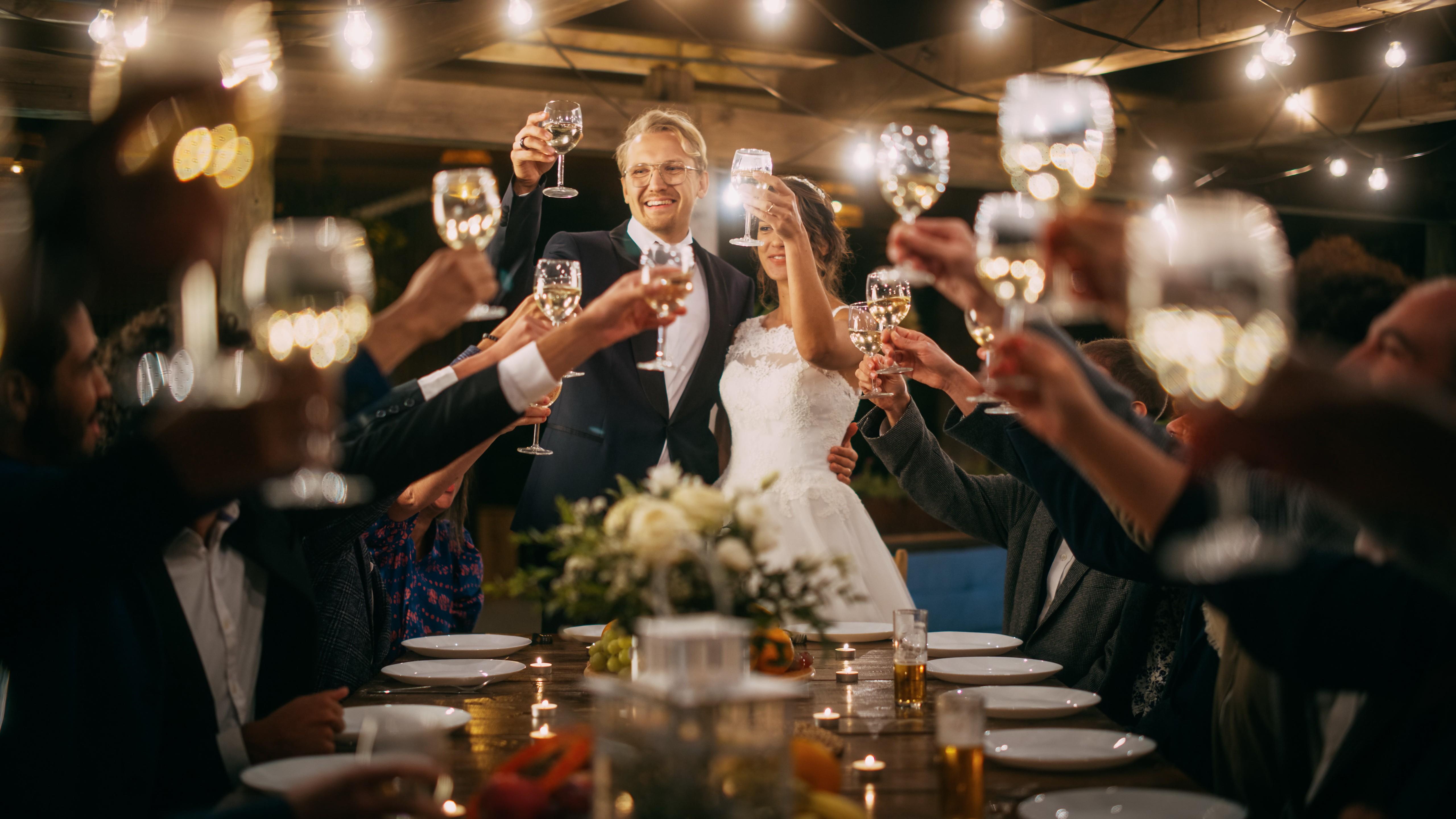 Guests raising glasses wedding toast