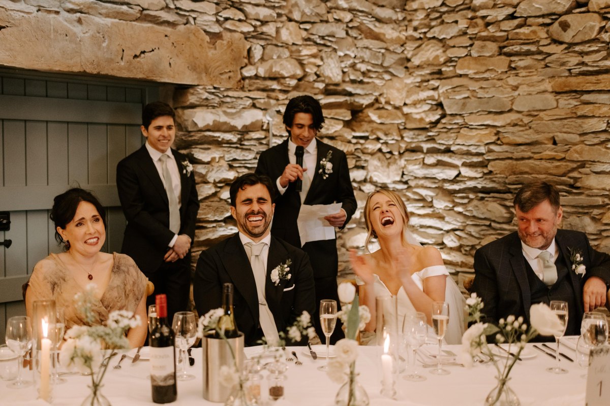 Wedding guests laughing during speech