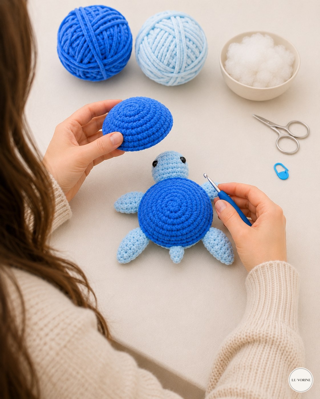 Comparing the domed top shell against the finished body before joining the no-sew plush turtle