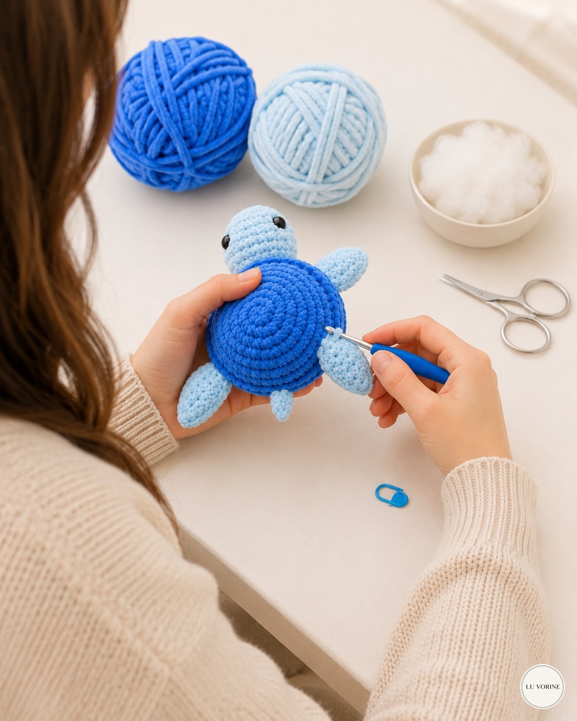 Holding the half-finished no-sew plush turtle with back flippers and tail already attached
