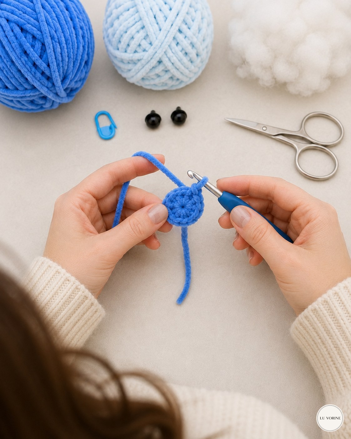 Overhead shot of hands crocheting the first round of the no-sew plush turtle shell base at home