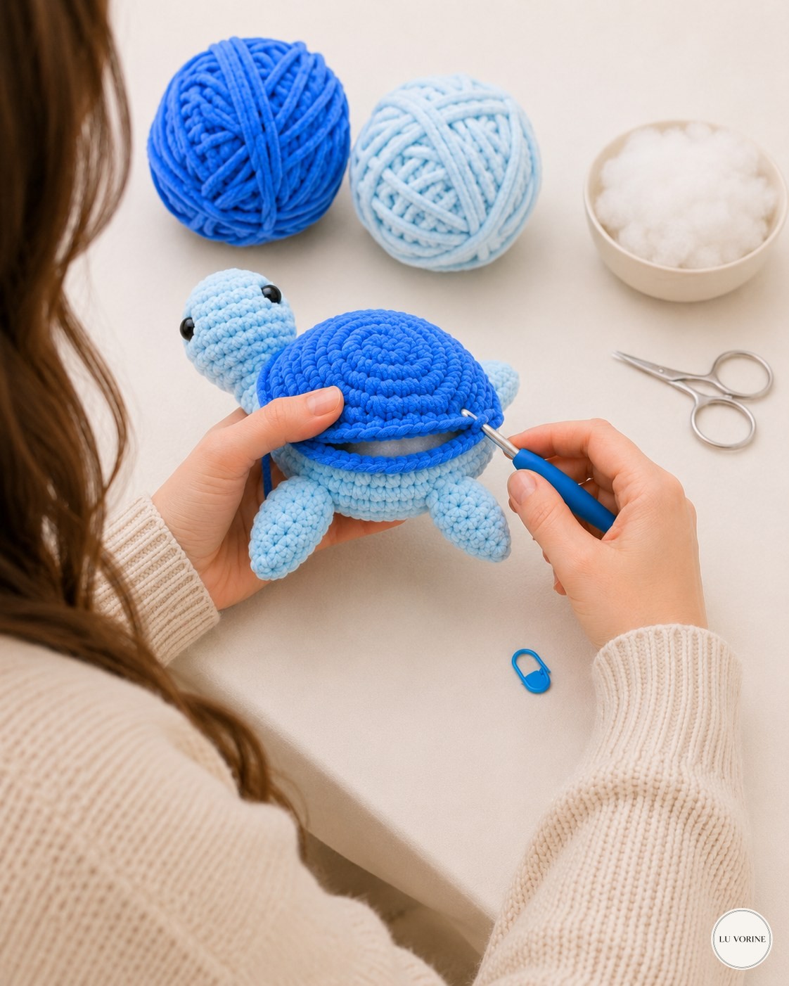 Single crocheting the two shell halves together on the no-sew plush turtle, opening still visible