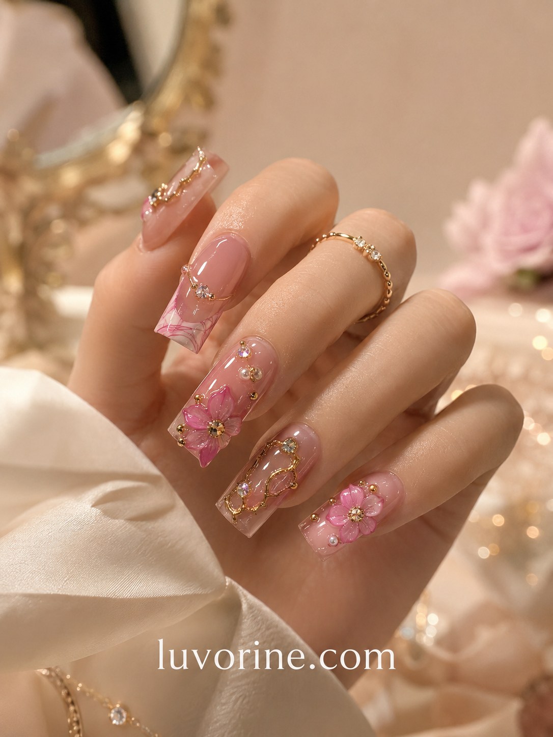 Pink short nails inspiration featuring 3D floral crystal accents on a longer coffin shape