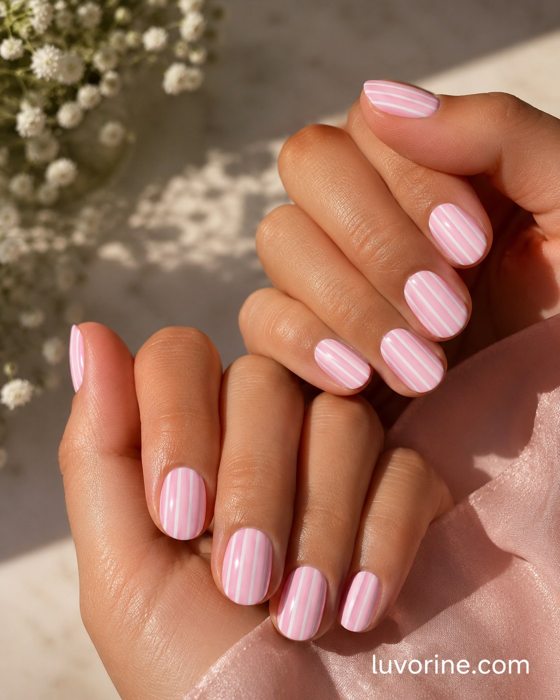Sunlit pink and white pinstripe pattern on short round pink short nails