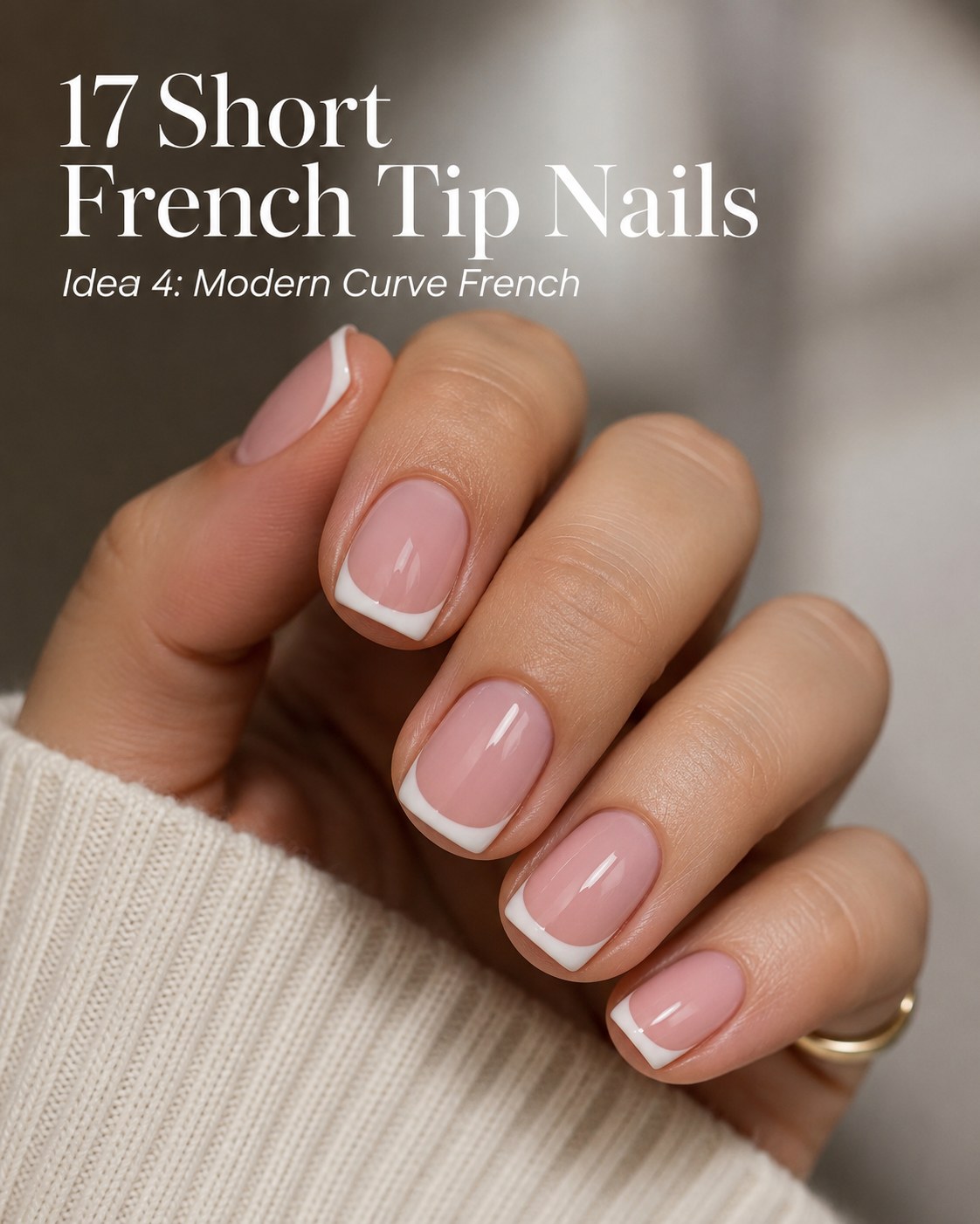 Modern short french tip nails with a deep curved white smile line for a graphic look