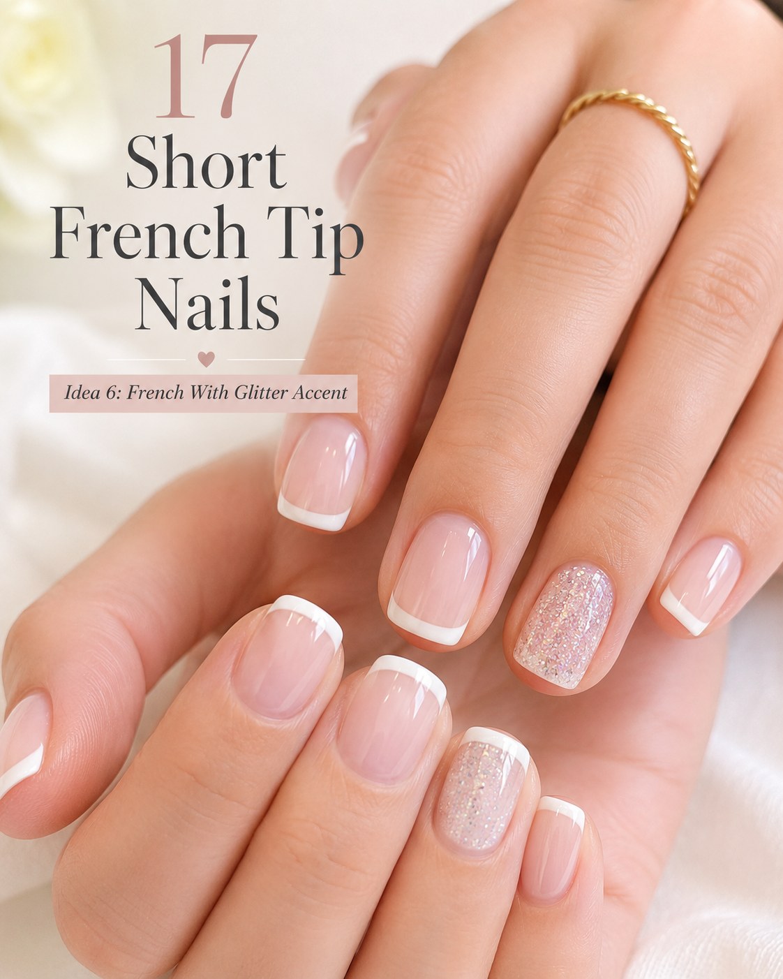 Short french tip nails with white tips and a fine silver glitter accent nail